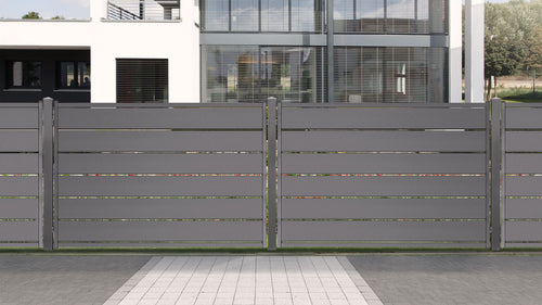 Grauer Sichtschutzzaun aus Aluminium Latten vor einem Haus